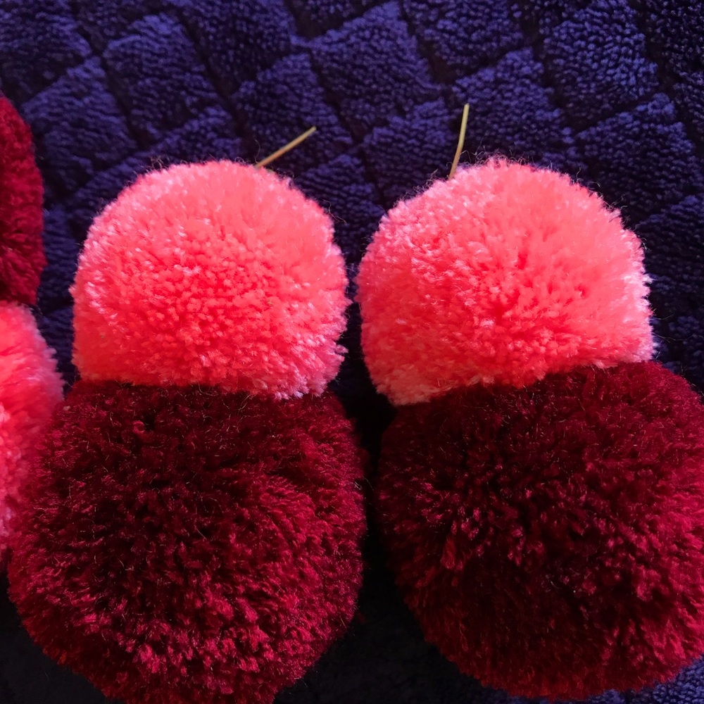 Two pairs custom made pom pom earrings.